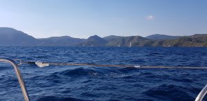 Photo showing the waters around Fethiye with blue skies and the yacht in the foreground