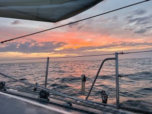 A beautiful orange sunset with the yacht rigging in the foreground