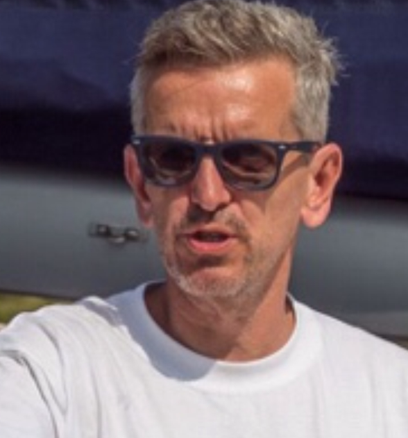 Headshot of Robert in a white tee shirt and sunglasses